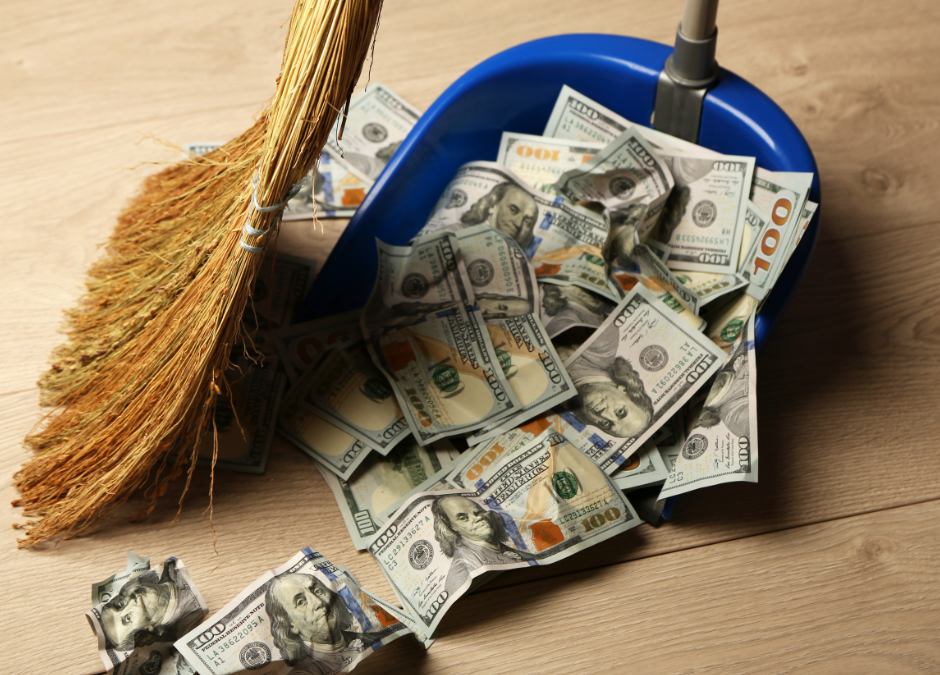 Sweeping money into a dustpan