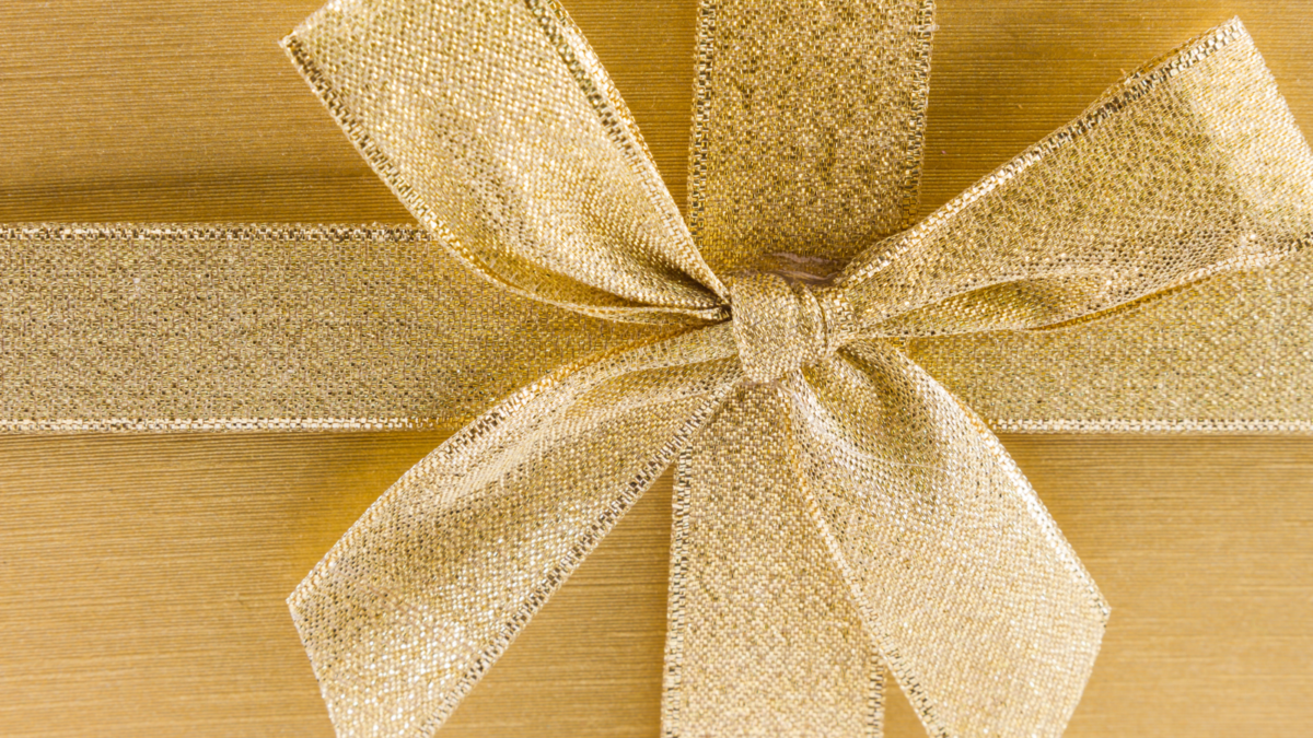 gold bow on gold gift box