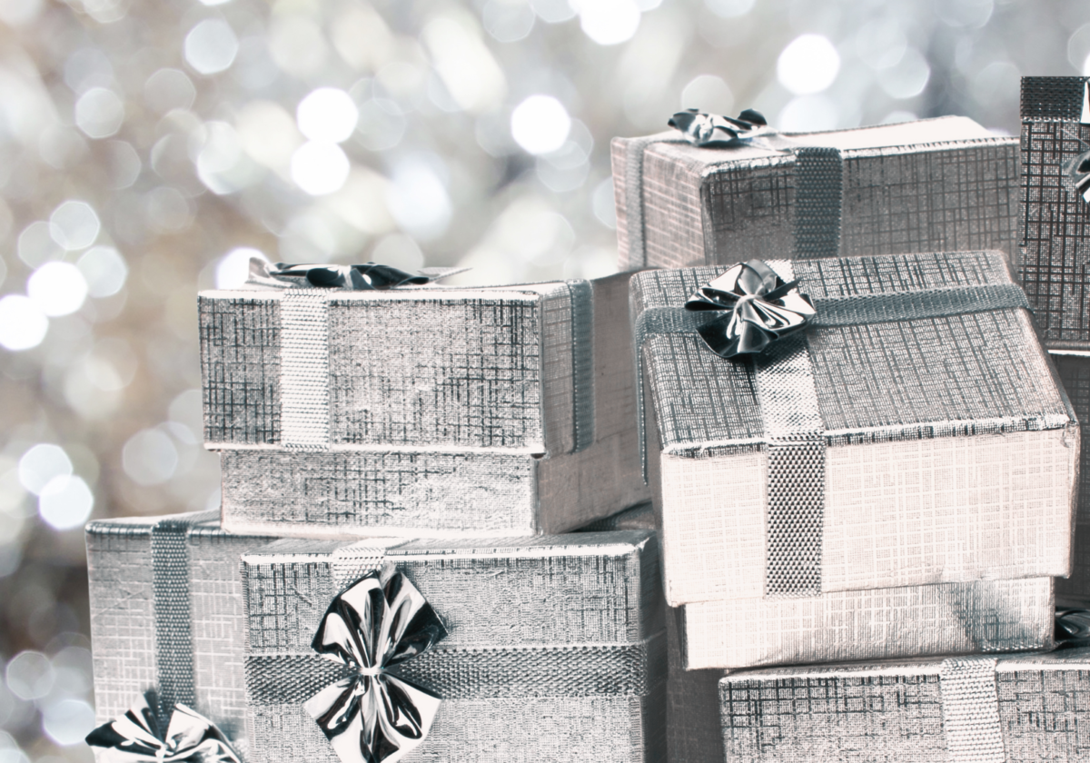 gifts wrapped in silver with sparkling silver background