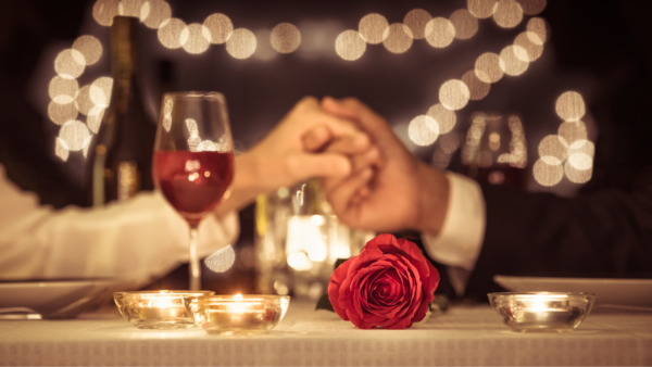Couple holding hands at Valentine's Day dinner