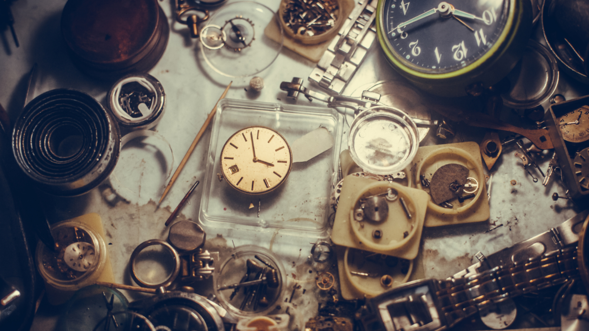 table full of old watches and jewelry